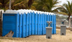 line of porta potties on the beach