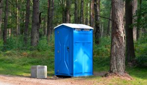 porta potty next to a trail