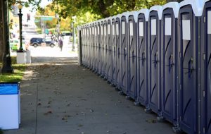 line of porta potties on the sidewalk