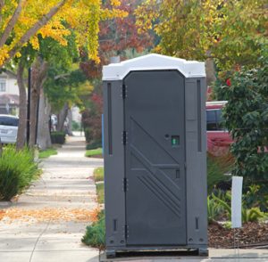porta potty on a sidewalk