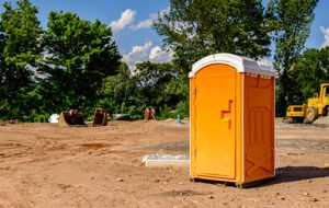 orange porta potty on a construction site